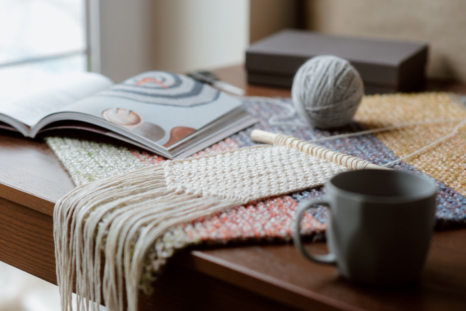 an open magazine and some textiles on a table