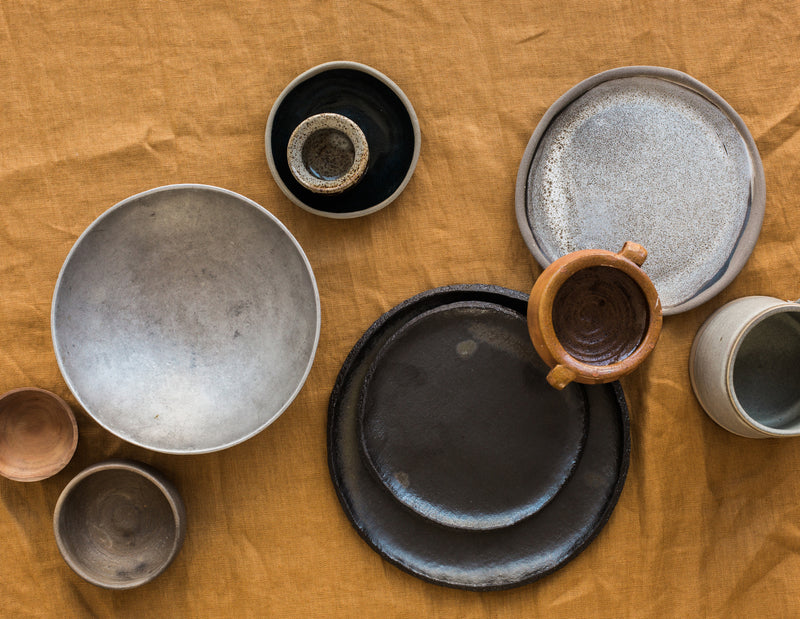 a flatlay of ceramics on a table cloth